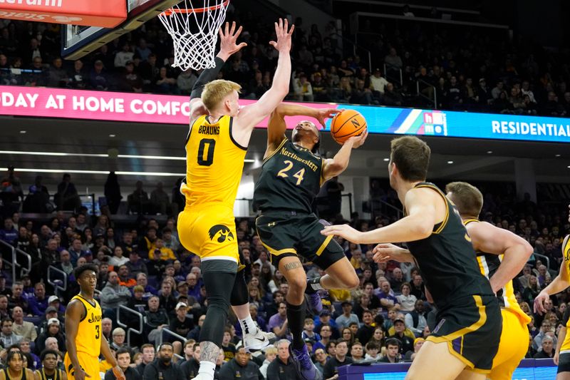 Feb 28, 2025; Evanston, Illinois, USA; Iowa Hawkeyes forward Even Brauns (0) defends Northwestern Wildcats guard K.J. Windham (24) during the second half at Welsh-Ryan Arena. Mandatory Credit: David Banks-Imagn Images