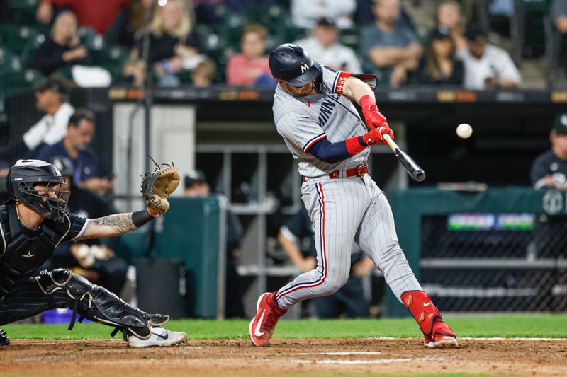 Sep 15, 2023; Chicago, Illinois, USA; Minnesota Twins catcher Ryan Jeffers (27) hits a two-run single against the Chicago White Sox during the ninth inning at Guaranteed Rate Field. Mandatory Credit: Kamil Krzaczynski-USA TODAY Sports