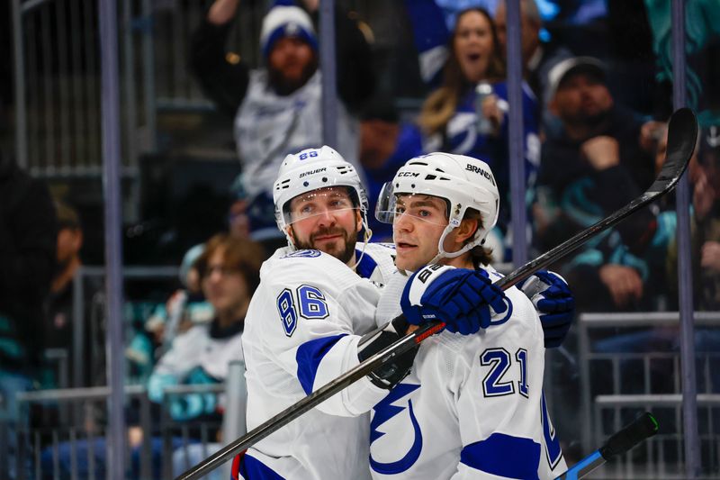 Dec 9, 2023; Seattle, Washington, USA; Tampa Bay Lightning right wing Nikita Kucherov (86) celebrates with center Brayden Point (21) after scoring a goal against the Seattle Kraken during the first period at Climate Pledge Arena. Mandatory Credit: Joe Nicholson-USA TODAY Sports