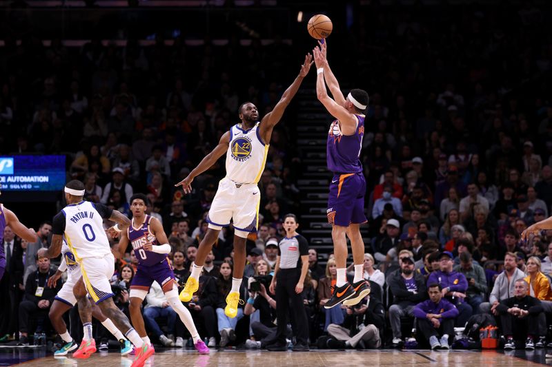 PHOENIX, ARIZONA - NOVEMBER 30: Devin Booker #1 of the Phoenix Suns attempts a three point shot over Andrew Wiggins #22 of the Golden State Warriors during the second half at Footprint Center on November 30, 2024 in Phoenix, Arizona. NOTE TO USER: User expressly acknowledges and agrees that, by downloading and or using this photograph, User is consenting to the terms and conditions of the Getty Images License Agreement.  (Photo by Chris Coduto/Getty Images)