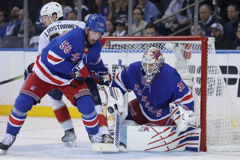 May 22, 2024; New York, New York, USA; New York Rangers defenseman Erik Gustafsson (56) and goaltender Igor Shesterkin (31) play the puck against Florida Panthers center Eetu Luostarinen (27) during the second period of game one of the Eastern Conference Final of the 2024 Stanley Cup Playoffs at Madison Square Garden. Mandatory Credit: Brad Penner-USA TODAY Sports