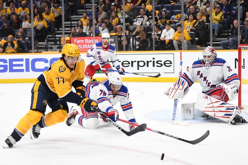 Dec 2, 2023; Nashville, Tennessee, USA; Nashville Predators right wing Luke Evangelista (77) skates after a puck knocked away by New York Rangers defenseman K'Andre Miller (79) during the third period at Bridgestone Arena. Mandatory Credit: Christopher Hanewinckel-USA TODAY Sports