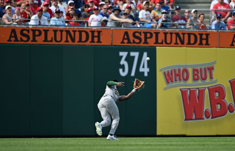 Jul 13, 2024; Philadelphia, Pennsylvania, USA; Oakland Athletics outfielder Daz Cameron (28) fields a fly ball against the Philadelphia Phillies in the first inning at Citizens Bank Park. Mandatory Credit: Kyle Ross-USA TODAY Sports