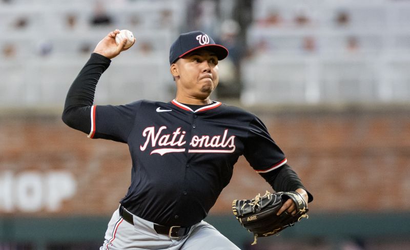 Aug 23, 2024; Cumberland, Georgia, USA; Washington Nationals pitcher Eduardo Salazar (62) pitches against the Atlanta Braves during the tenth inning at Truist Park. Mandatory Credit: Jordan Godfree-USA TODAY Sports