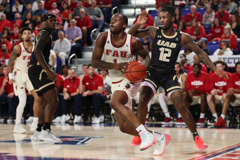 Jan 14, 2024; Boca Raton, Florida, USA; Florida Atlantic Owls guard Johnell Davis (1) drives to the basket ahead of UAB Blazers guard Tony Toney (12) during the second half at Eleanor R. Baldwin Arena. Mandatory Credit: Sam Navarro-USA TODAY Sports