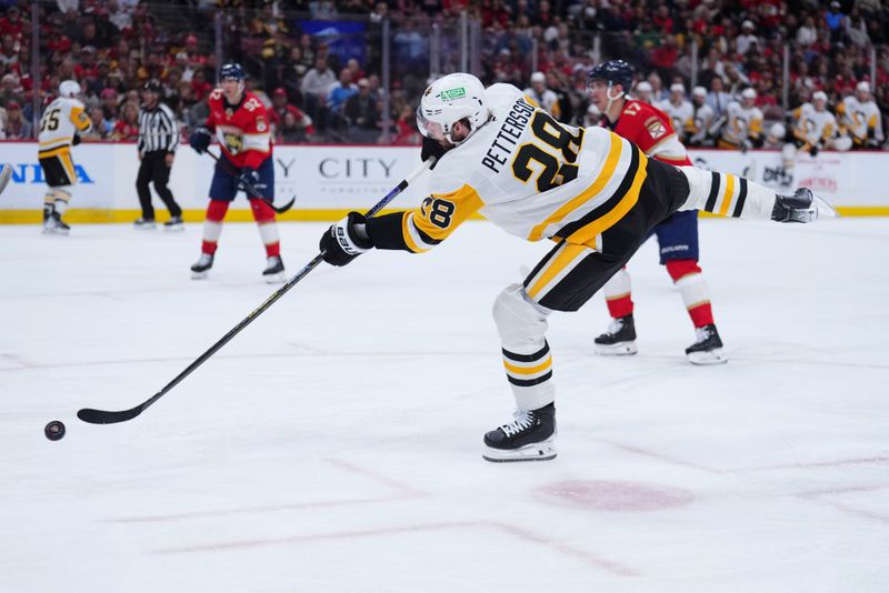 Jan 3, 2025; Sunrise, Florida, USA; Pittsburgh Penguins right wing Kevin Hayes (13) shoots the puck against the Florida Panthers during the second period at Amerant Bank Arena. Mandatory Credit: Rich Storry-Imagn Images