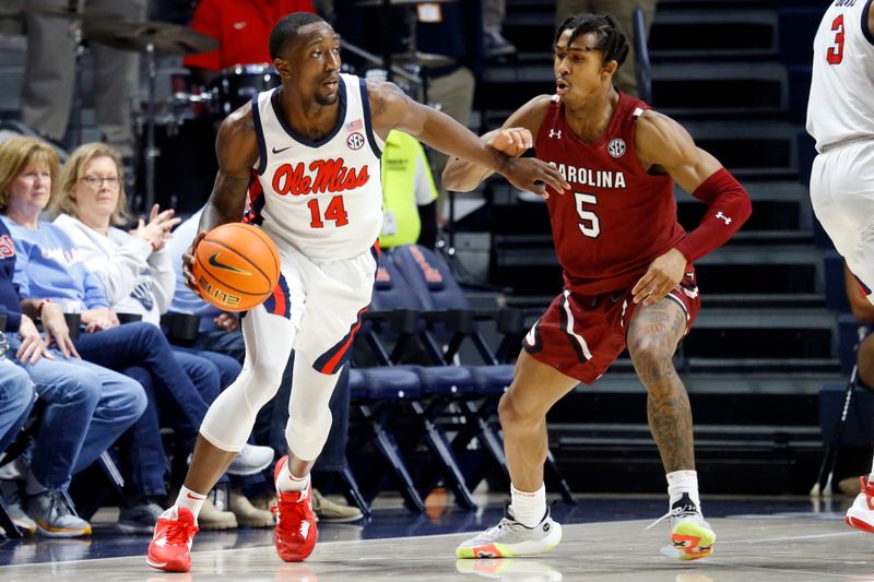 Feb 11, 2023; Oxford, Mississippi, USA; Mississippi Rebels guard Tye Fagan (14) dribbles as South Carolina Gamecocks guard Meechie Johnson (5) defends during the first half at The Sandy and John Black Pavilion at Ole Miss. Mandatory Credit: Petre Thomas-USA TODAY Sports