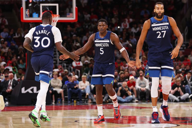 CHICAGO, ILLINOIS - OCTOBER 16: Julius Randle #30, Anthony Edwards #5 and Rudy Gobert #27 of the Minnesota Timberwolves celebrate a basket against the Chicago Bulls during the second half of a preseason game at the United Center on October 16, 2024 in Chicago, Illinois. NOTE TO USER: User expressly acknowledges and agrees that, by downloading and or using this photograph, User is consenting to the terms and conditions of the Getty Images License Agreement.  (Photo by Michael Reaves/Getty Images)