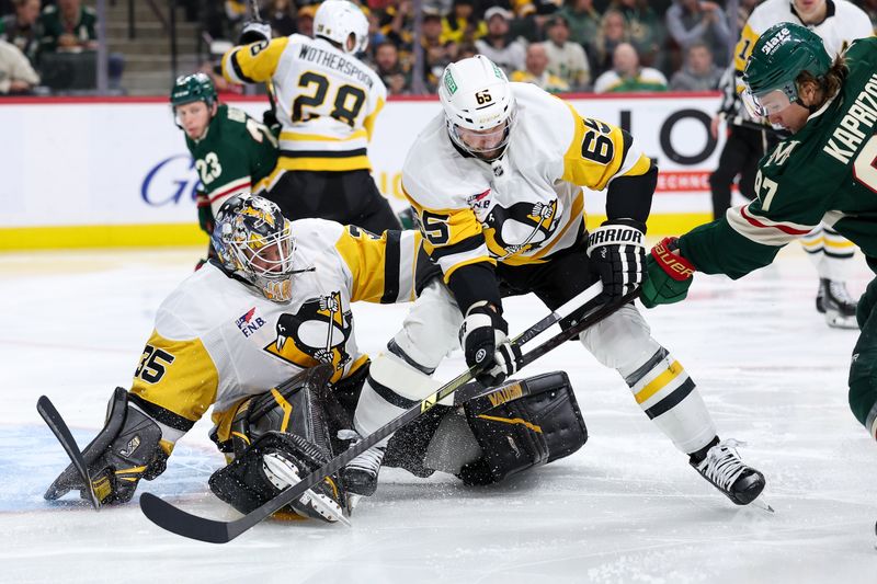 Oct 30, 2025; Saint Paul, Minnesota, USA; Pittsburgh Penguins goaltender Tristan Jarry (35) makes a save against Minnesota Wild left wing Kirill Kaprizov (97) during the second period at Grand Casino Arena. Mandatory Credit: Matt Krohn-Imagn Images