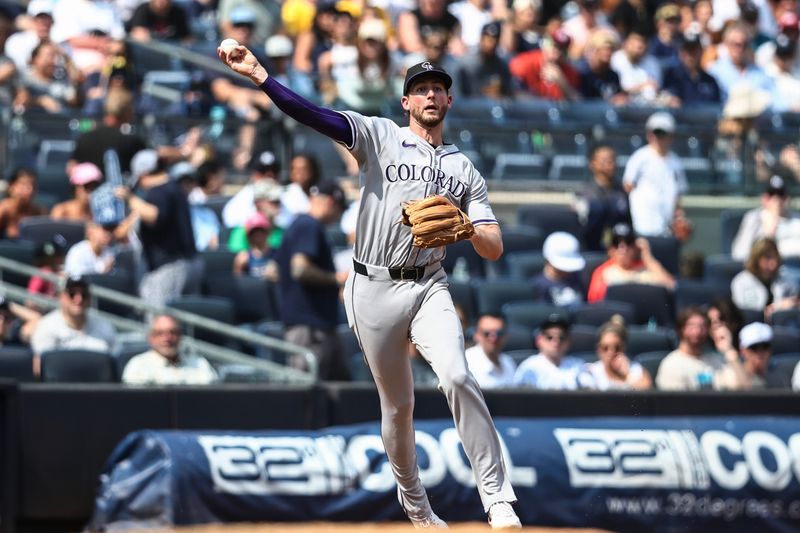 Aug 25, 2024; Bronx, New York, USA;  Colorado Rockies third baseman Ryan McMahon (24) throws a runner out at first base in the fourth inning against the New York Yankees at Yankee Stadium. Mandatory Credit: Wendell Cruz-USA TODAY Sports