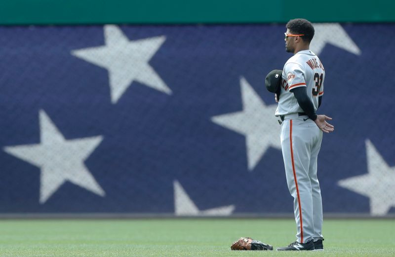 Jul 16, 2023; Pittsburgh, Pennsylvania, USA; San Francisco Giants first baseman LaMonte Wade Jr. (31) stands for the playing of the National Anthem against the Pittsburgh Pirates at PNC Park. Mandatory Credit: Charles LeClaire-USA TODAY Sports