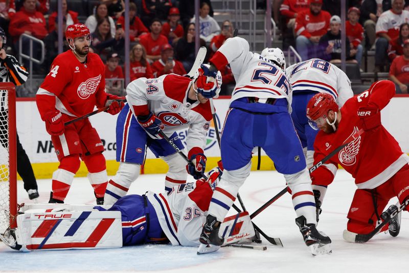 Apr 15, 2024; Detroit, Michigan, USA;  Montreal Canadiens goaltender Sam Montembeault (35) makes a save on Detroit Red Wings left wing J.T. Compher (37) in the second period at Little Caesars Arena. Mandatory Credit: Rick Osentoski-USA TODAY Sports