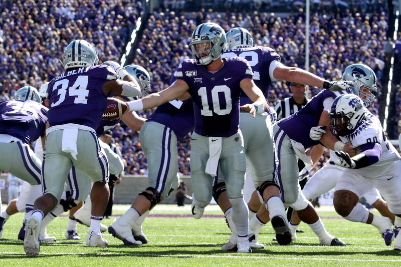 Oct 19, 2019; Manhattan, KS, USA; Kansas State Wildcats quarterback Skylar Thompson (10) hands off to running back James Gilbert (34) during the first quarter of a game against the TCU Horned Frogs at Bill Snyder Family Stadium. Mandatory Credit: Scott Sewell-USA TODAY Sports