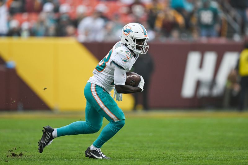 Miami Dolphins running back De'Von Achane (28) runs with the ball after making a catch during the second half of an NFL football game against the Washington Commanders, Sunday, Dec. 2, 2023, in Landover, Md. (AP Photo/Terrance Williams)