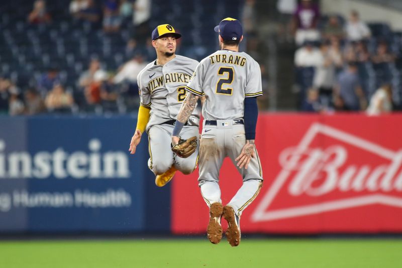 Sep 9, 2023; Bronx, New York, USA;  Milwaukee Brewers shortstop Willy Adames (27) and second baseman Brice Turang (2) celebrate after defeating the New York Yankees 9-2 at Yankee Stadium. Mandatory Credit: Wendell Cruz-USA TODAY Sports