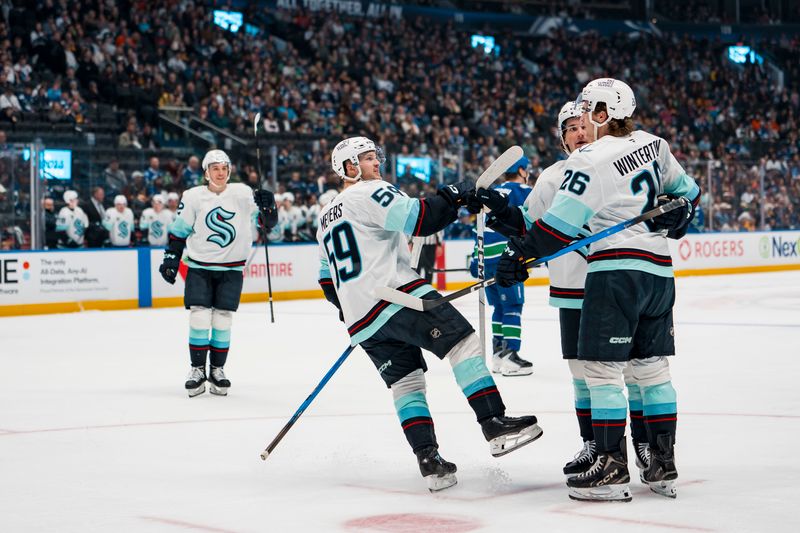 Sep 26, 2025; Vancouver, British Columbia, CAN; Seattle Kraken forward Ben Meyers (59), defenseman Tyson Jugnauth (83) and forward Ryan Winterton (26) celebrate Jugnauth’s goal against the Vancouver Canucks in the second period at Rogers Arena. Mandatory Credit: Bob Frid-Imagn Images
