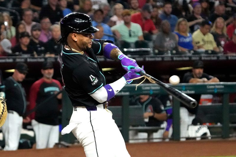 Jun 3, 2024; Phoenix, Arizona, USA; Arizona Diamondbacks second base Ketel Marte (4) hits a single against the San Francisco Giants in the first inning at Chase Field. Mandatory Credit: Rick Scuteri-USA TODAY Sports