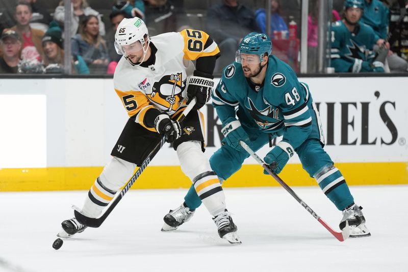 Nov 4, 2023; San Jose, California, USA; Pittsburgh Penguins defenseman Erik Karlsson (65) skates with the puck against San Jose Sharks center Tomas Hertl (48) during the first period at SAP Center at San Jose. Mandatory Credit: Darren Yamashita-USA TODAY Sports