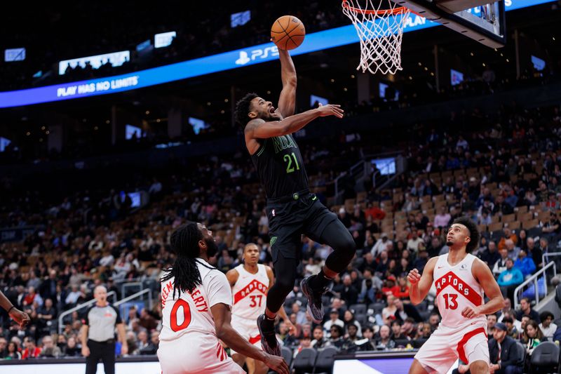 TORONTO, CANADA - MARCH 5: Izaiah Brockington #21 of the New Orleans Pelicans drives to the net against the Toronto Raptors in the second half of their NBA game at Scotiabank Arena on March 5, 2024 in Toronto, Canada. NOTE TO USER: User expressly acknowledges and agrees that, by downloading and or using this photograph, User is consenting to the terms and conditions of the Getty Images License Agreement. (Photo by Cole Burston/Getty Images)