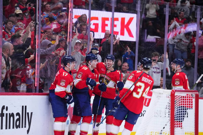 Jan 3, 2025; Sunrise, Florida, USA; Florida Panthers left wing Matthew Tkachuk (19) celebrates with teammates after scoring against the Pittsburgh Penguins during the third period at Amerant Bank Arena. Mandatory Credit: Rich Storry-Imagn Images