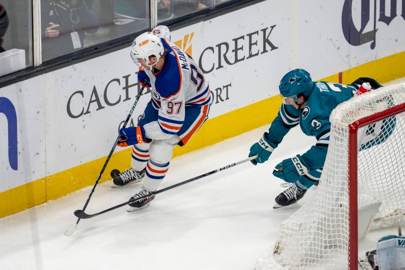 oDec 28, 2023; San Jose, California, USA; Edmonton Oilers center Connor McDavid (97) controls the puck against San Jose Sharks defenseman Henry Thrun (3) during the third period at SAP Center at San Jose. Mandatory Credit: Neville E. Guard-USA TODAY Sports