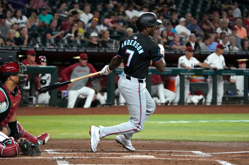 May 24, 2024; Phoenix, Arizona, USA; Miami Marlins shortstop Tim Anderson (7) hits a single against the Arizona Diamondbacks in the second inning at Chase Field. Mandatory Credit: Rick Scuteri-USA TODAY Sports