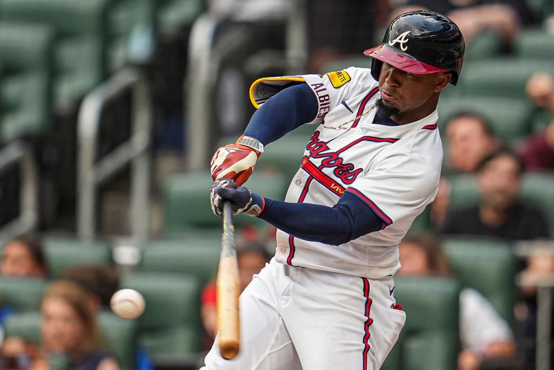 Jul 4, 2024; Cumberland, Georgia, USA; Atlanta Braves second baseman Ozzie Albies (1) hits a double against the San Francisco Giants during the first inning at Truist Park. Mandatory Credit: Dale Zanine-USA TODAY Sports