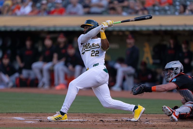 Jul 5, 2024; Oakland, California, USA;  Oakland Athletics outfielder Miguel Andujar (22) hits a solo home run during the first inning against the Baltimore Orioles at Oakland-Alameda County Coliseum. Mandatory Credit: Stan Szeto-USA TODAY Sports