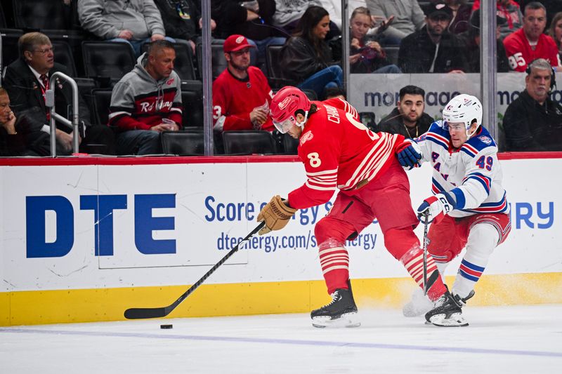 Nov 7, 2025; Detroit, Michigan, USA; Detroit Red Wings defenseman Ben Chiarot (8) and New York Rangers right wing Jaroslav Chmelar (49) battle for the puck during the first period at Little Caesars Arena. Mandatory Credit: Tim Fuller-Imagn Images