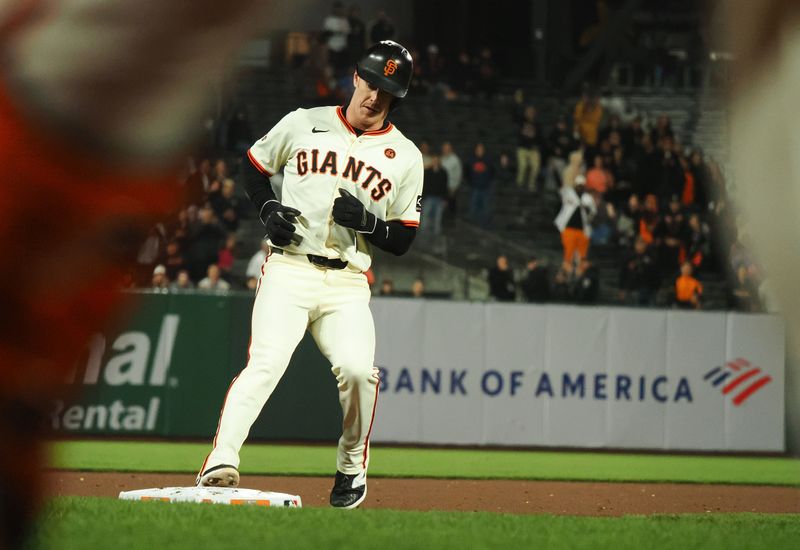 Sep 12, 2024; San Francisco, California, USA; San Francisco Giants pinch hitter Mark Canha (16) reaches third base against the Milwaukee Brewers during the ninth inning at Oracle Park. Mandatory Credit: Kelley L Cox-Imagn Images