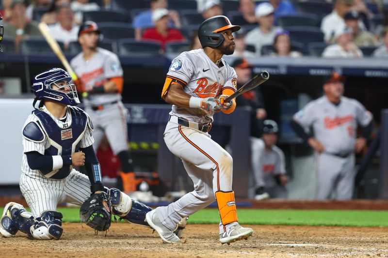 Jun 19, 2024; Bronx, New York, USA;  Baltimore Orioles center fielder Cedric Mullins (31) hits an RBI single in the tenth inning against the New York Yankees at Yankee Stadium. Mandatory Credit: Wendell Cruz-USA TODAY Sports