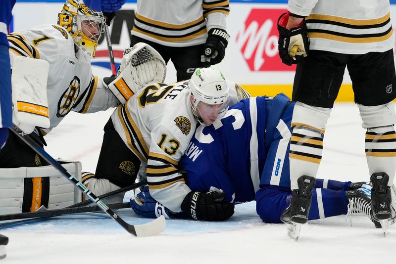 Mar 4, 2024; Toronto, Ontario, CAN; Boston Bruins forward Charlie Coyle (13) holds Toronto Maple Leafs forward Auston Matthews (34) down on the ice after a scramble for a rebound in front of Boston Bruins goaltender Jeremy Swayman (1) during the third period at Scotiabank Arena. Mandatory Credit: John E. Sokolowski-USA TODAY Sports