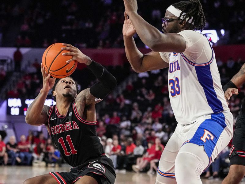 Feb 28, 2023; Athens, Georgia, USA; Georgia Bulldogs guard Justin Hill (11) stops in front of  Florida Gators center Jason Jitoboh (33) during the second half at Stegeman Coliseum. Mandatory Credit: Dale Zanine-USA TODAY Sports