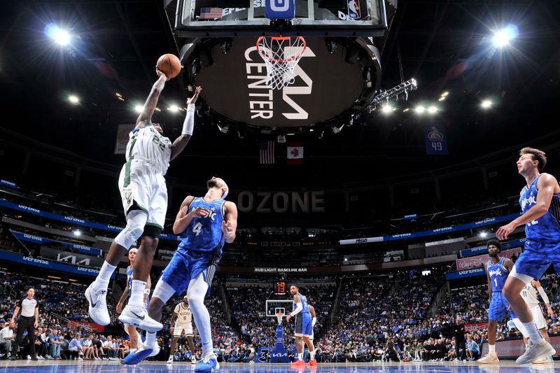 ORLANDO, FL - APRIL 14: Khris Middleton #22 of the Milwaukee Bucks drives to the basket during the game against the Orlando Magic on April 14, 2024 at Kia Center in Orlando, Florida. NOTE TO USER: User expressly acknowledges and agrees that, by downloading and or using this photograph, User is consenting to the terms and conditions of the Getty Images License Agreement. Mandatory Copyright Notice: Copyright 2024 NBAE (Photo by Fernando Medina/NBAE via Getty Images)