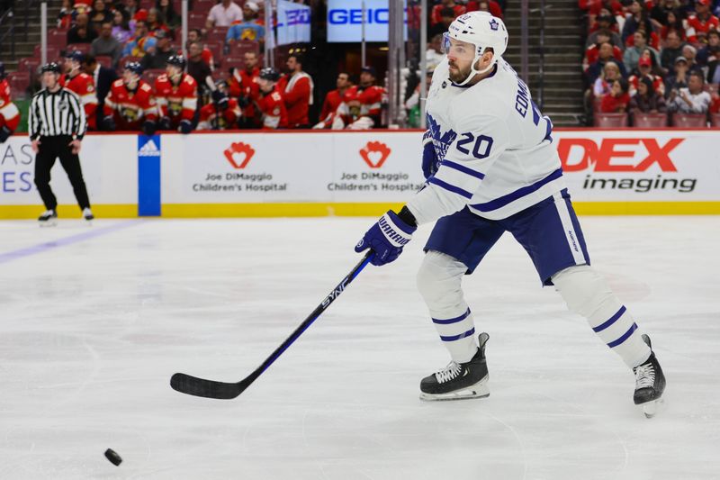 Apr 16, 2024; Sunrise, Florida, USA; Toronto Maple Leafs defenseman Joel Edmundson (20) moves the puck against the Florida Panthers during the second period at Amerant Bank Arena. Mandatory Credit: Sam Navarro-USA TODAY Sports