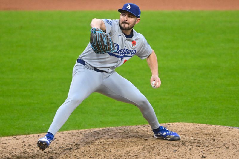May 26, 2025; Cleveland, Ohio, USA; Los Angeles Dodgers relief pitcher Alex Vesia (51) delivers a pitch in the seventh inning against the Cleveland Guardians at Progressive Field. Mandatory Credit: David Richard-Imagn Images