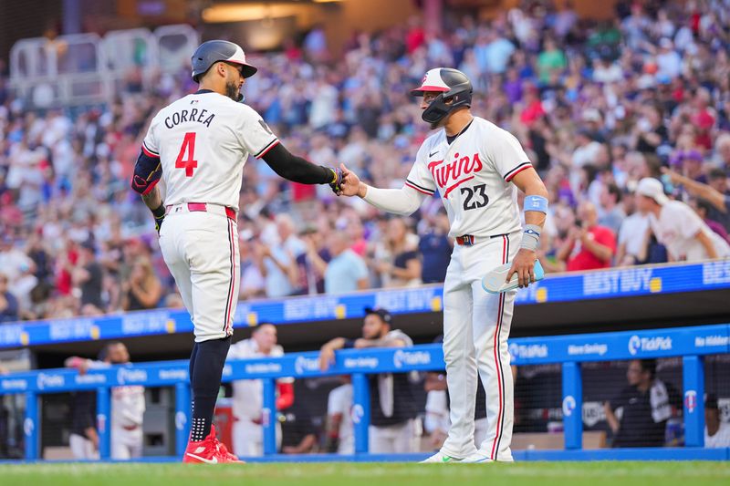 Jun 13, 2024; Minneapolis, Minnesota, USA; Minnesota Twins shortstop Carlos Correa (4) celebrates his home run with third base Royce Lewis (23) against the Oakland Athletics in the seventh inning at Target Field. Mandatory Credit: Brad Rempel-USA TODAY Sports