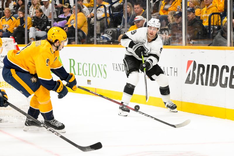 Nov 4, 2024; Nashville, Tennessee, USA;  Los Angeles Kings right wing Adrian Kempe (9) passes the puck as Nashville Predators left wing Filip Forsberg (9) blocks the pass during the second period at Bridgestone Arena. Mandatory Credit: Steve Roberts-Imagn Images