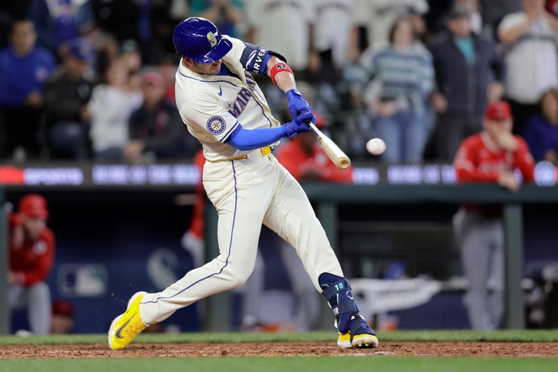 Jun 2, 2024; Seattle, Washington, USA; Seattle Mariners designated hitter Mitch Garver hits a three RBI double against the Los Angeles Angels during the eighth inning at T-Mobile Park. Mandatory Credit: John Froschauer-USA TODAY Sports