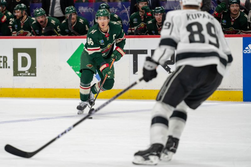 Feb 21, 2023; Saint Paul, Minnesota, USA; Minnesota Wild defenseman Jared Spurgeon (46) advances the puck, watched by Los Angeles Kings center Rasmus Kupari (89) in the second period at Xcel Energy Center. Mandatory Credit: Matt Blewett-USA TODAY Sports