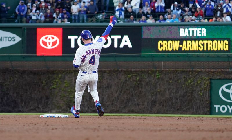 Apr 27, 2025; Chicago, Illinois, USA; Chicago Cubs outfielder Pete Crow-Armstrong (4) gestures after hitting a one run double against the Philadelphia Phillies during the second inning at Wrigley Field. Mandatory Credit: David Banks-Imagn Images