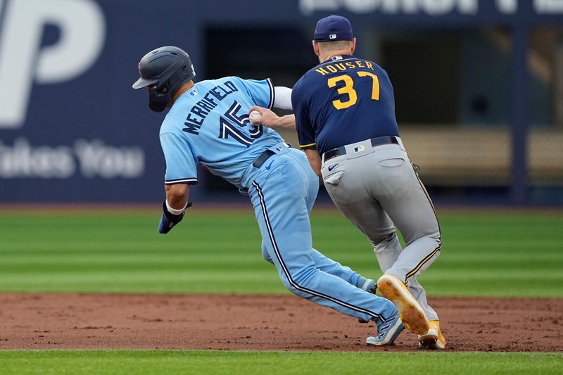 May 30, 2023; Toronto, Ontario, CAN; Milwaukee Brewers starting pitcher Adrian Houser (37) catches Toronto Blue Jays left fielder Whit Merrifield (15) in a rundown during the first inning at Rogers Centre. Mandatory Credit: John E. Sokolowski-USA TODAY Sports