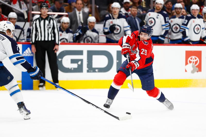 Mar 24, 2024; Washington, District of Columbia, USA; Washington Capitals center Hendrix Lapierre (29) shoots the puck past Winnipeg Jets center Vladislav Namestnikov (7) during the third period at Capital One Arena. Mandatory Credit: Amber Searls-USA TODAY Sports