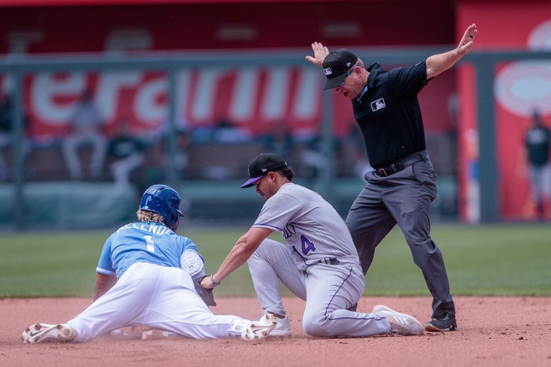 Jun 4, 2023; Kansas City, Missouri, USA; Colorado Rockies shortstop Ezequiel Tovar (14) tags Kansas City Royals right fielder MJ Melendez (1) as the umpire signals safe during the fifth inning at Kauffman Stadium. Mandatory Credit: William Purnell-USA TODAY Sports