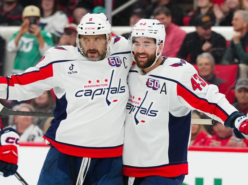 Apr 2, 2025; Raleigh, North Carolina, USA;  Washington Capitals left wing Alex Ovechkin (8) clebrates his goal with  right wing Tom Wilson (43) against the Carolina Hurricanes during the second period at Lenovo Center. Mandatory Credit: James Guillory-Imagn Images