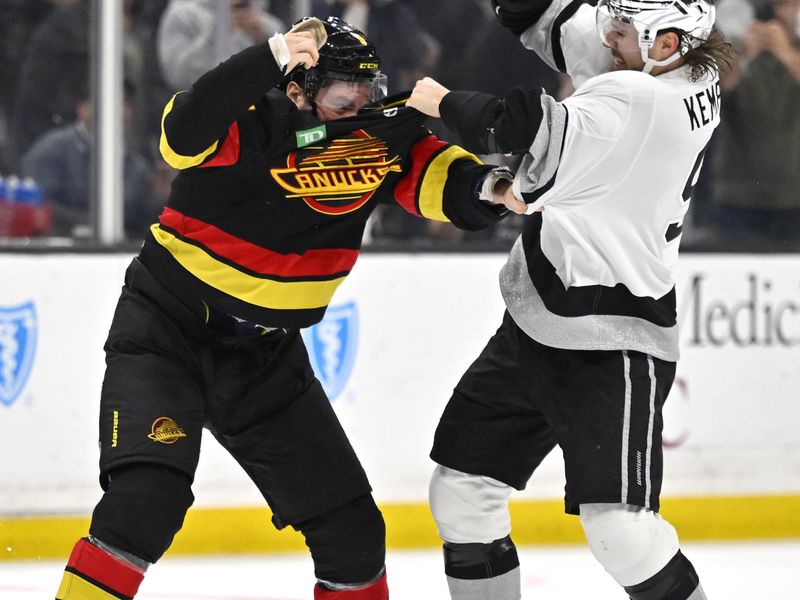 Apr 10, 2023; Los Angeles, California, USA;  Vancouver Canucks center J.T. Miller (9) and Los Angeles Kings right wing Adrian Kempe (9) fight in the second period at Crypto.com Arena. Mandatory Credit: Jayne Kamin-Oncea-USA TODAY Sports