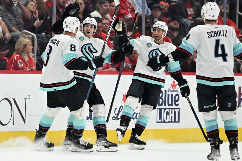 Oct 24, 2023; Detroit, Michigan, USA; Seattle Kraken defenseman Brian Dumoulin (8) celebrates with Seattle Kraken left wing Tye Kartye (52) (center left) right wing Jordan Eberle (7) (center right) and defenseman Justin Schultz (4) after the Kraken scored a goal against the Detroit Red Wings in the second period at Little Caesars Arena. Mandatory Credit: Lon Horwedel-USA TODAY Sports