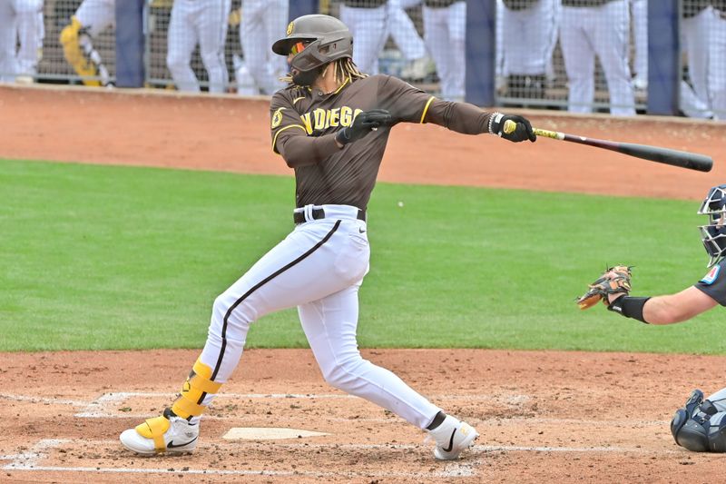 Feb 26, 2024; Peoria, Arizona, USA;  San Diego Padres right fielder Fernando Tatis Jr. (23) at bat in the third inning against the Cleveland Guardians during a spring training game at Peoria Sports Complex. Mandatory Credit: Matt Kartozian-USA TODAY Sports