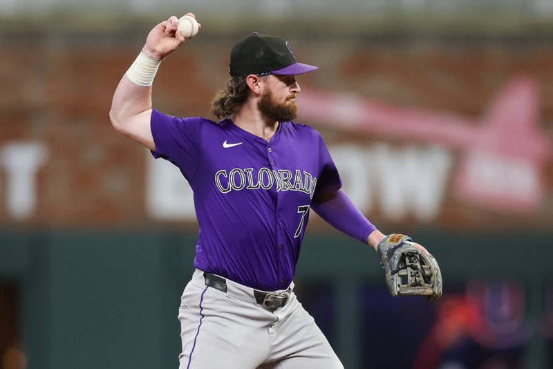 Sep 3, 2024; Atlanta, Georgia, USA; Colorado Rockies second baseman Brendan Rodgers (7) turns a double play against the Atlanta Braves in the sixth inning at Truist Park. Mandatory Credit: Brett Davis-Imagn Images 