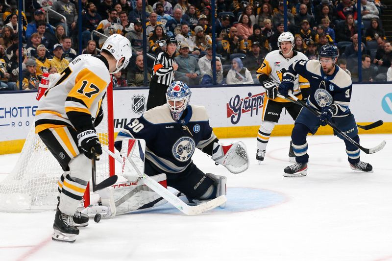 Nov 15, 2024; Columbus, Ohio, USA; Columbus Blue Jackets goalie Elvis Merzlikins (90) makes a save on the shot from Pittsburgh Penguins right wing Bryan Rust (17) during the third period at Nationwide Arena. Mandatory Credit: Russell LaBounty-Imagn Images